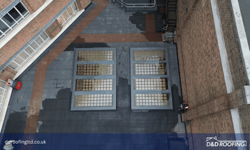 Refurbished flat roof and pedestrian access area at Leeds Train Station with Bauder waterproofing and anti-slip walkway system by D&D Roofing Ltd